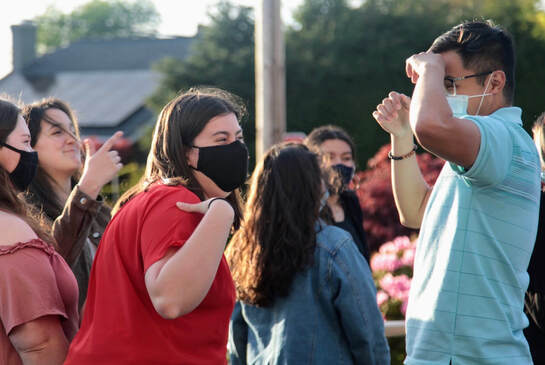 Picture of a few WWU students with masks on after a Sunday Mass having a good time.